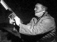 Image of a Provisional IRA member holding a Thompson submachine-gun 