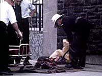 Image of a fireman shovelling a mutilated body into a plastic bag at Oxford St. bus station, Belfast